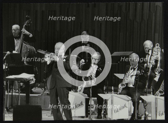 The Ted Heath Orchestra in concert, London 1985. Pictured are Lennie Bush (double bass), Kenny Baker Artist: Denis Williams