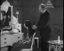 Female Civilian Having Her Hair Cut Into a 'Shingle' by a Male Civilian Hairdresser, 1920. Creator: British Pathe Ltd.