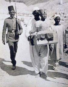 Mannequin or bust of Tutankhamun being carried from his tomb, Valley of the Kings, Egypt, 1922. Artist: Harry Burton