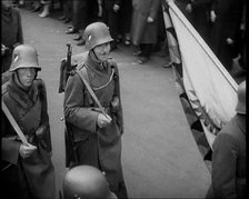 German Soldiers Marching Down a Street as a Crowd Watches, 1930s. Creator: British Pathe Ltd.