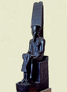 Statue of the god Amon protecting Tutankhamen, made in black granite, 1350 b.C., partially destro…