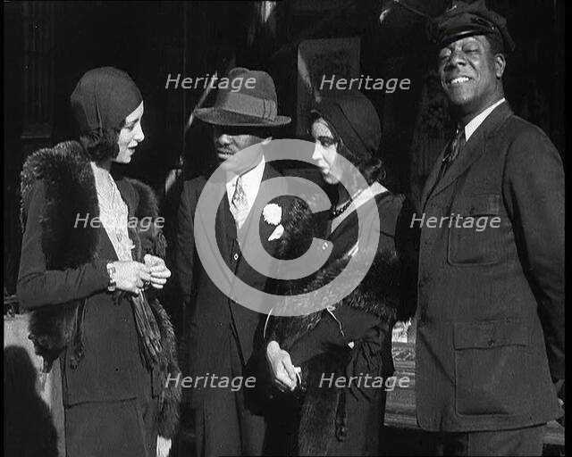 Smartly Dressed People in Conversation On the Streets of New York City, 1932. Creator: British Pathe Ltd.