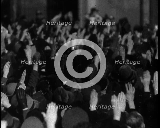 Crowd With Right Arms Raised in a Nazi Salute in the Direction of the..., 1937. Creator: British Pathe Ltd.