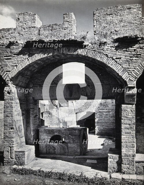 Partly ruined buildings in Ostia identified as a tavern or hot-food shop (thermopolium)..., 1920-9. Creator: Domenico Anderson.