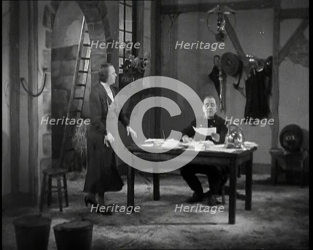 Comedian Robb Wilton On Set Playing a Fire Brigade Officer and Sitting at a Desk With Papers...,1938 Creator: British Pathe Ltd.