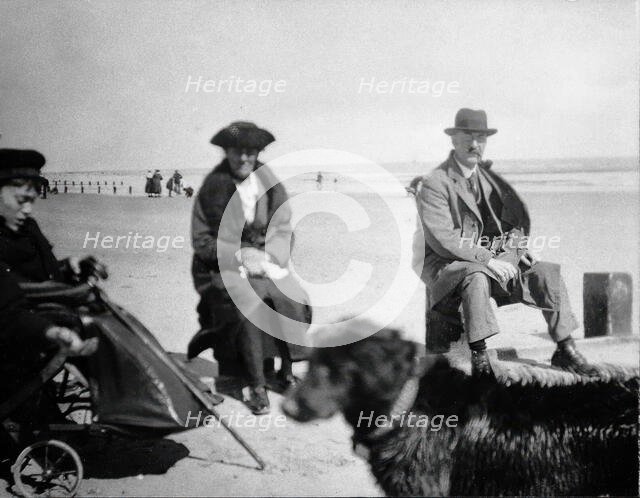 A physically disabled boy sitting in a wheelchair on a beach,  c1910/1925. Creator: Unknown.