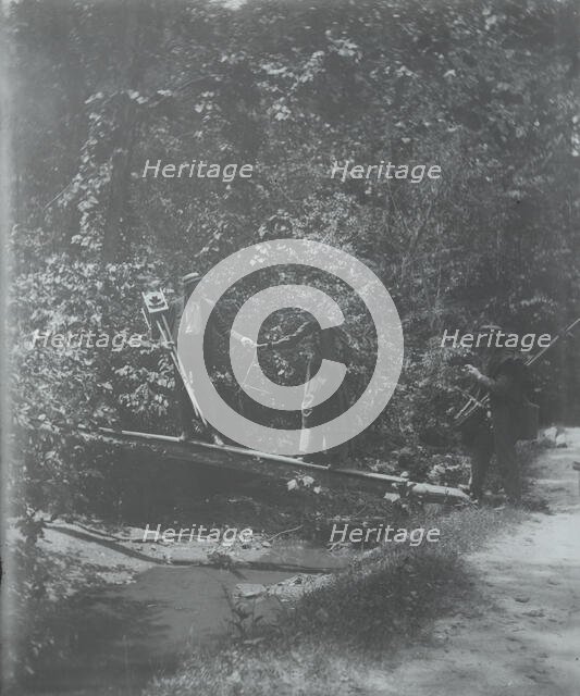Group crossing footbridge with cameras, between 1885 and 1900. Creator: Frances Benjamin Johnston.
