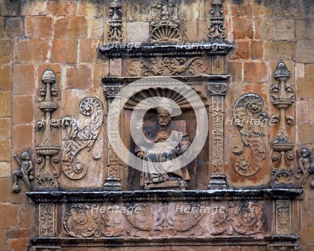Front door of St. Peter's Cathedral, crowned by the seated image of Saint Peter Pope, embedded in…