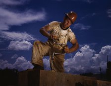 A carpenter at the TVA's new Douglas dam on the French Broad River, Tenn., 1942. Creator: Alfred T Palmer.