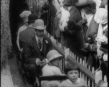 King George V and Queen Mary of the United Kingdom Sit in a Model Train As It Passes..., 1924. Creator: British Pathe Ltd.