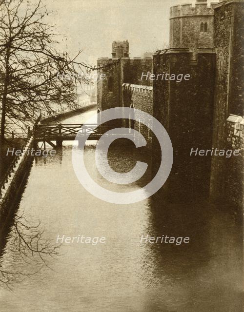 Flood waters in the moat at the Tower of London, 1928, (1935). Creator: Unknown.