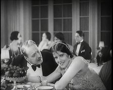 Scene from the Film 'Champagne': Two Actors Sitting at a Table in a Nightclub, 1920s. Creator: British Pathe Ltd.