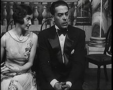 Jack Buchanan and June Knight Sitting on a Bench Together. Buchanan Looking Uncomfortable...,1920s Creator: British Pathe Ltd.