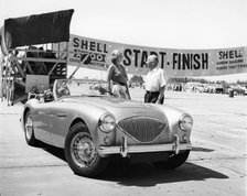 Donald Healey with an Austin Healey at a motor race. Artist: Unknown