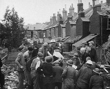 An Injured Child Being Carried from a Bombed Out House, 1940. Creator: British Pathe Ltd.