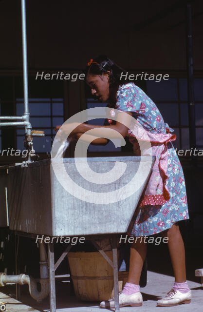 Young woman at the community laundry on Saturday afternoon, FSA ... camp, Robstown, Tex., 1942. Creator: Arthur Rothstein.