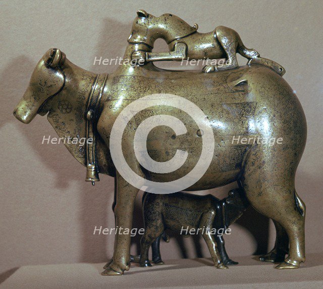 Cast bronze zebu-cow suckling her calf while a lion attacks her back, 13th century. Artist: Unknown