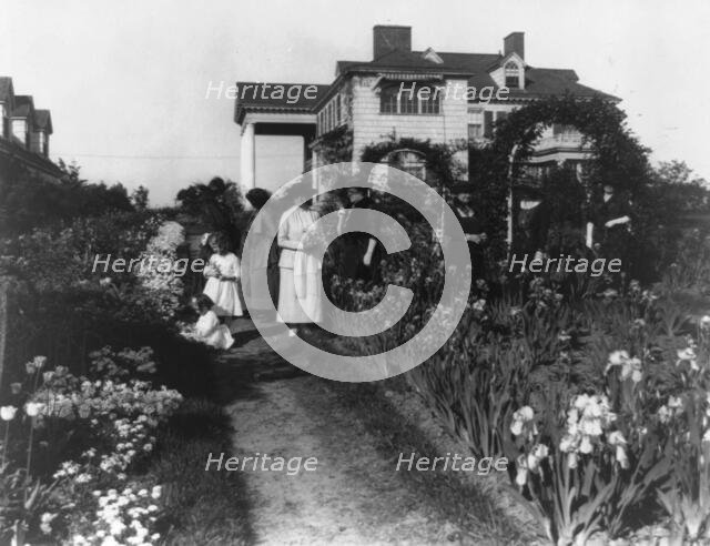 Seven women and two small girls in the garden of Mrs. John W. Paris...New York, between 1909 & 1927. Creator: Frances Benjamin Johnston.