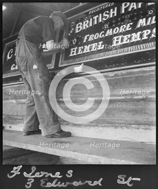Barge painter Frank Jones, of 3 Edward Street, at work, Leighton Buzzard, Bedfordshire, 1910-60. Creator: George R Long.