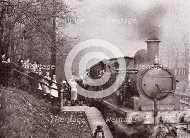 Passengers queuing for a steam rain at Rowntree's halt, York, Yorkshire, 1934. Artist: Unknown