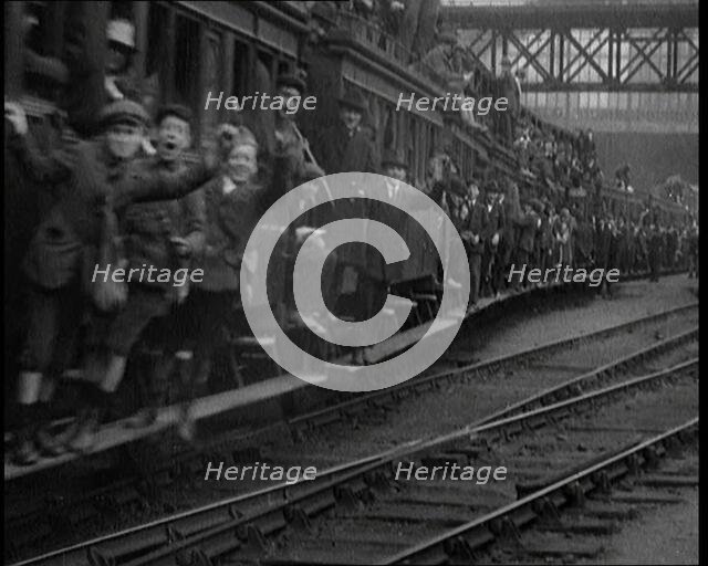 French People Hanging Onto the Outside of a Packed Train as It Drives Along, 1920. Creator: British Pathe Ltd.