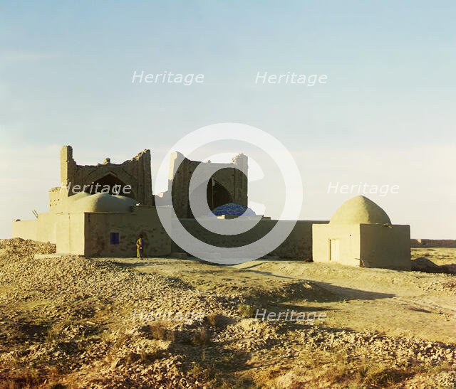 Walled adobe structure with domes and arches in desert area, with man posed..., between 1905-1915. Creator: Sergey Mikhaylovich Prokudin-Gorsky.
