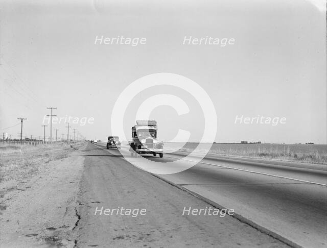 Migrants on the road, between Tulare and Fresno, California, 1939. Creator: Dorothea Lange.