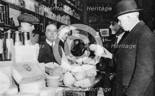 A customer inspects a haggis, London, 1926-1927. Artist: Unknown