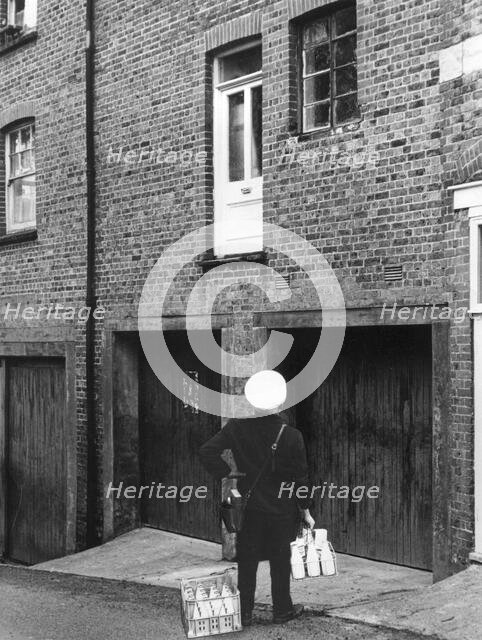 Confused milkman confronted with a doorstep on the first floor, c1955. Creator: Arthur Charles Kirby Ware.