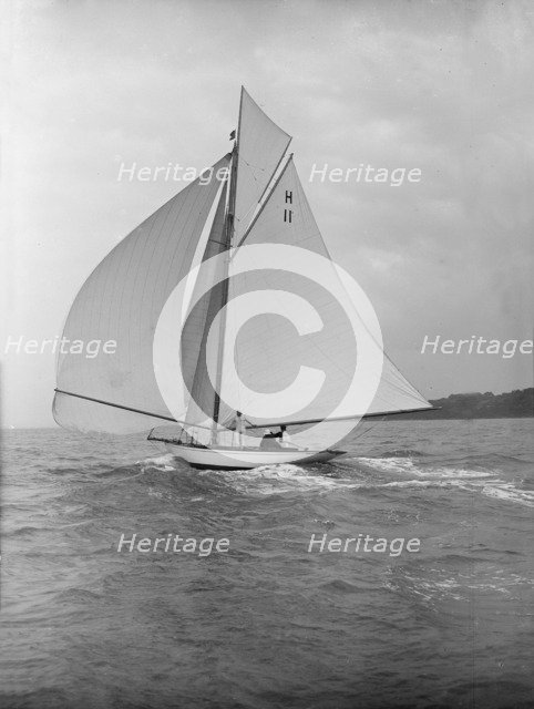 'Ventana' (H11), an early 8 Metre yacht, running downwind under spinnaker, 1913. Creator: Kirk & Sons of Cowes.