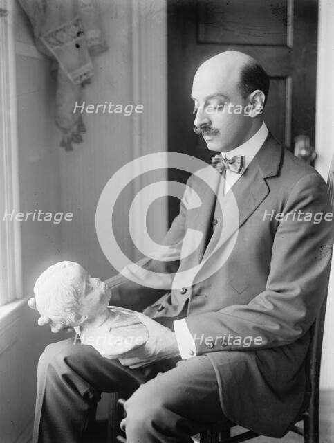 Greek Statuette Held By A.C. Vouros, 1913. Creator: Harris & Ewing.