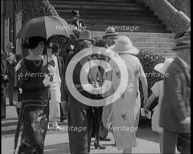 Civilians Walking Outdoors Wearing Evening Outfits and Hats, 1920. Creator: British Pathe Ltd.