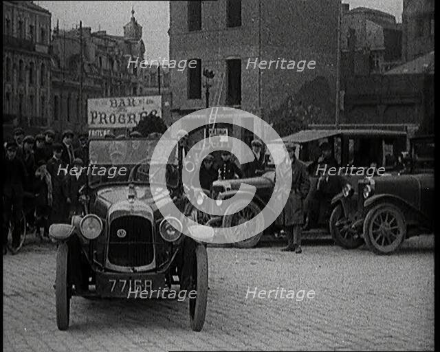 Male Civilian Driving a Car Out of a Parking Space On the Streets of London Watched By..., 1920s. Creator: British Pathe Ltd.