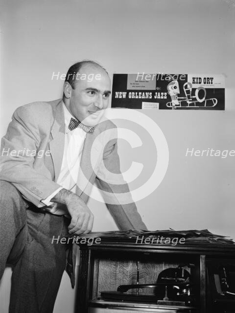 Portrait of George Avakian in his office or home, New York, N.Y.(?), 1938. Creator: William Paul Gottlieb.