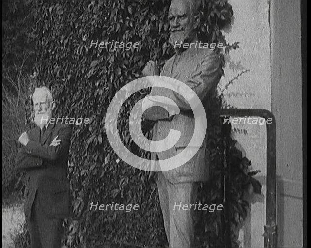 Playwright George Bernard Shaw Standing Next To a Statue of Himself, 1920s. Creator: British Pathe Ltd.