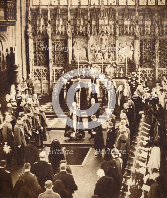 King Edward VIII sprinkles earth on his father's coffin, 1936.  Artist: Unknown.