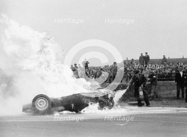 Tony Brooks' car on fire at the British Grand Prix, Silverstone, Northamptonshire,1956. Artist: Unknown
