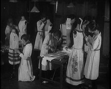 Young Female Civilians Sewing Dresses on Mannequins in an Arts Class, 1920. Creator: British Pathe Ltd.