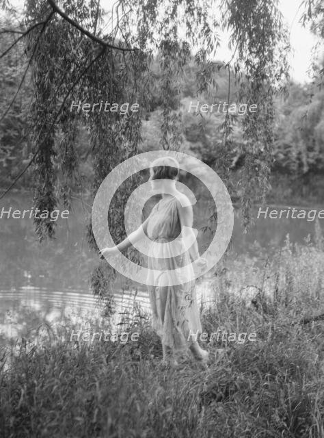 Rossin, F., Miss, standing outdoors, 1928 Creator: Arnold Genthe.