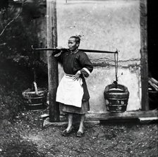 Foochow, Fukien province, China: a woman carrying buckets of night-soil, 1869 (1981). Creator: John Thomson.