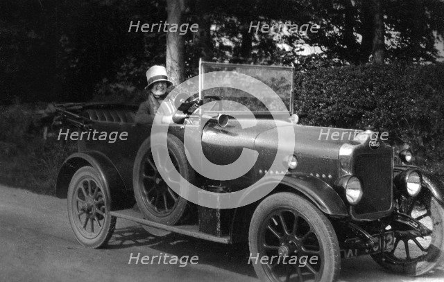 Woman driving a car, 1930. Artist: Unknown