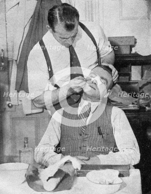 England captain Eddie Hapgood receives treatment for a broken nose after a match with Italy, 1934.Artist: Topical Press Agency