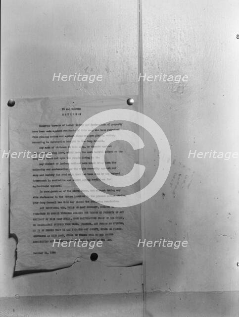Camp bulletin board in Shafter camp for migratory workers, FSA camp, California, 1938. Creator: Dorothea Lange.