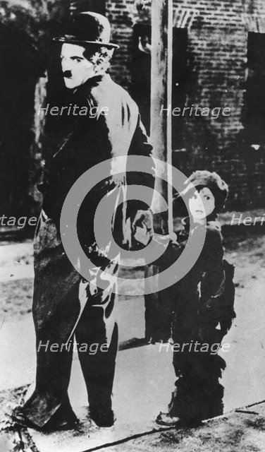 Charlie Chaplin and Jackie Coogan in 'The Kid', 1921. Artist: Unknown