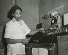 African American Private Hannah Wills developing an x-ray film in the x-ray laboratory..., 1943. Creator: Unknown.