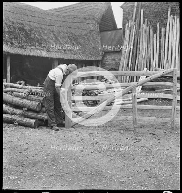 Man making a field gate in the village of Aston, Cote, Shifford and Chimney, Oxfordshire, 1930-50. Creator: George R Long.