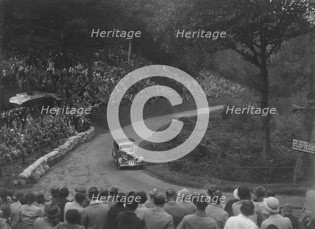 Ford V8 saloon competing in the Shelsley Walsh Hillclimb, Worcestershire, 1935. Artist: Bill Brunell.