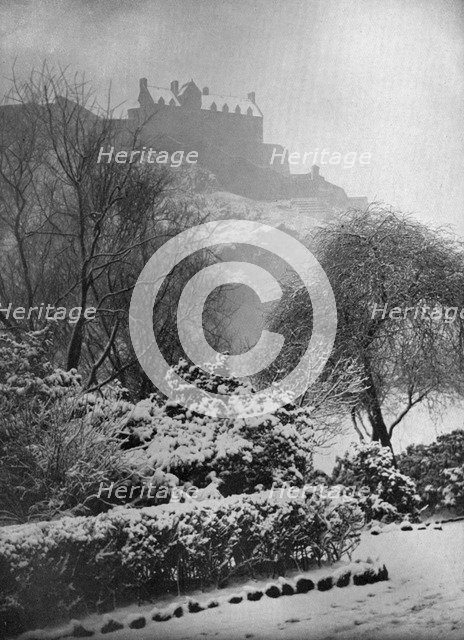 Edinburgh Castle in the snow, from Princes Street Gardens, Scotland, 1924-1926.Artist: W Reid