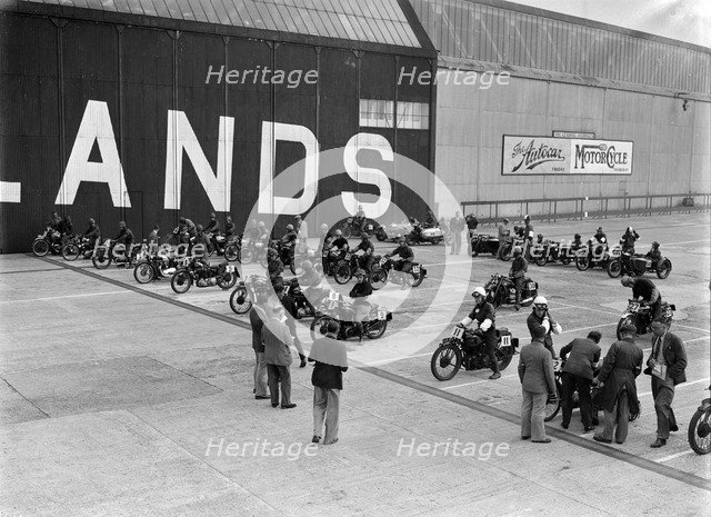 Motorcycles on the start line at the MCC Members Meeting, Brooklands, 10 September 1938. Artist: Bill Brunell.