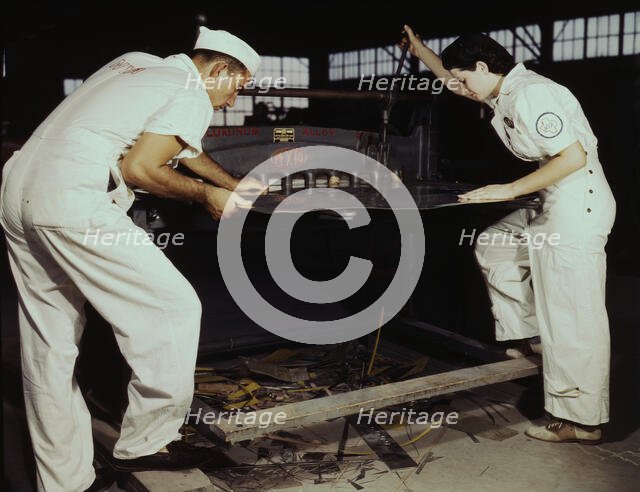Learning to work a cutting machine, these two NYA employees...Corpus Christi, Texas, 1942. Creator: Howard Hollem.
